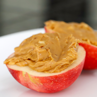 Apple with peanut butter, one of the health snack ideas from our expert