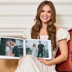 Hannah Brown holding a photo book.