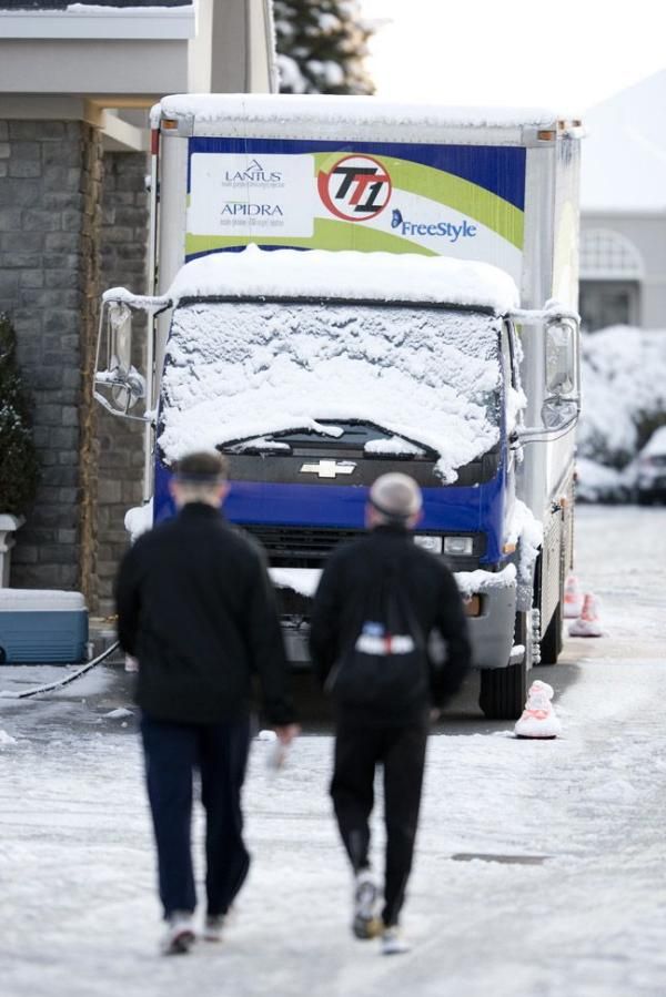 The Team Type 1 truck is covered in snow.
