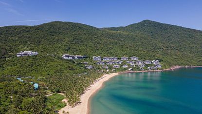 The hotel is set in a lush tropical hillside forest and has a pristine beach