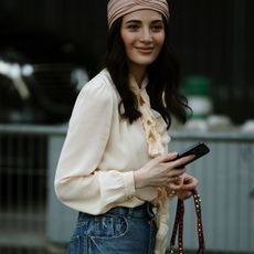Woman wearing boho ruffle blouse and jeans