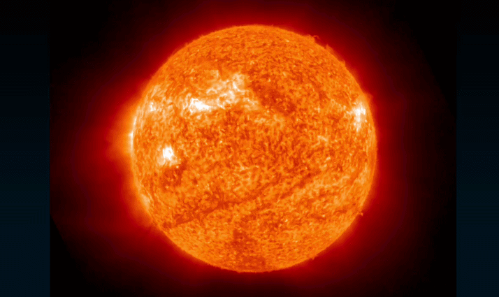 fiery solar flare erupts from the upper right of the sun.