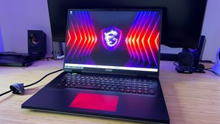 MSI Titan 18 HX gaming laptop on a wooden desk