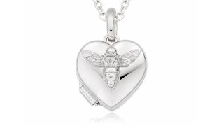 A close up of a silver heart-shaped locket with a bee on from Beaverbrooks.