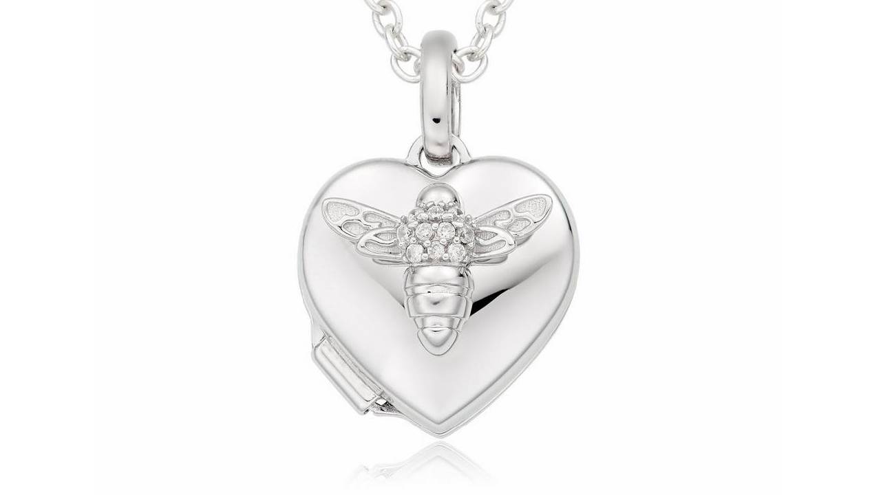 A close up of a silver heart-shaped locket with a bee on from Beaverbrooks.