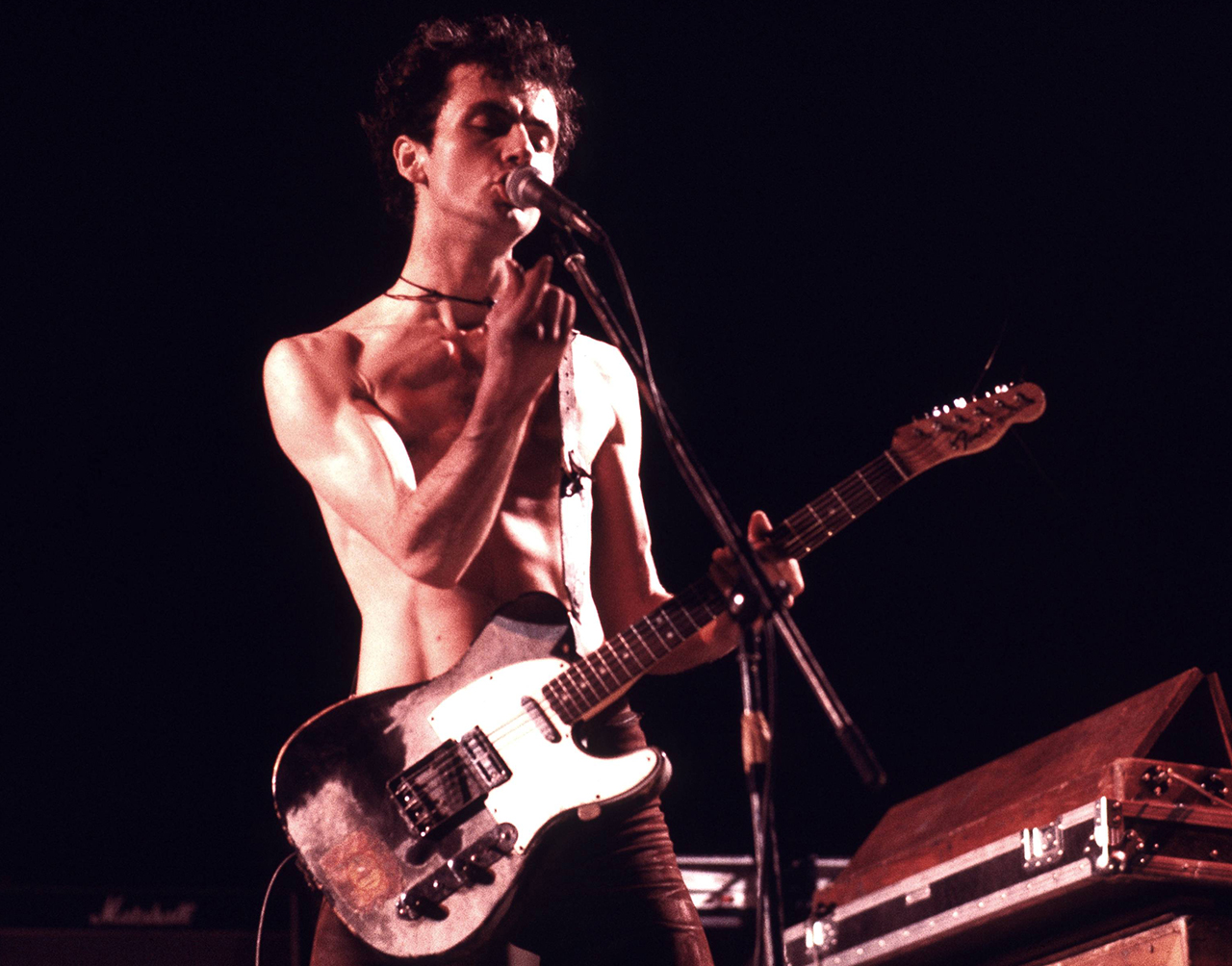 Hugh Cornwell performs onstage with the Stranglers