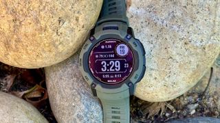 The Garmin Instinct 2X Solar sitting on a pile of rocks