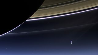 This rare image taken on July 19, 2013, by NASA's Cassini spacecraft has shows Saturn's rings and our planet Earth and its moon in the same frame. At the time, Cassini was 2013 from a distance of about 898.414 million miles (1.445858 billion kilometers) from Earth. It is only one footprint in a mosaic of 33 footprints covering the entire Saturn ring system (including Saturn itself) taken by Cassini's wide-angle camera.
