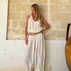 Jeanette Madsen in white embroidered hem pants