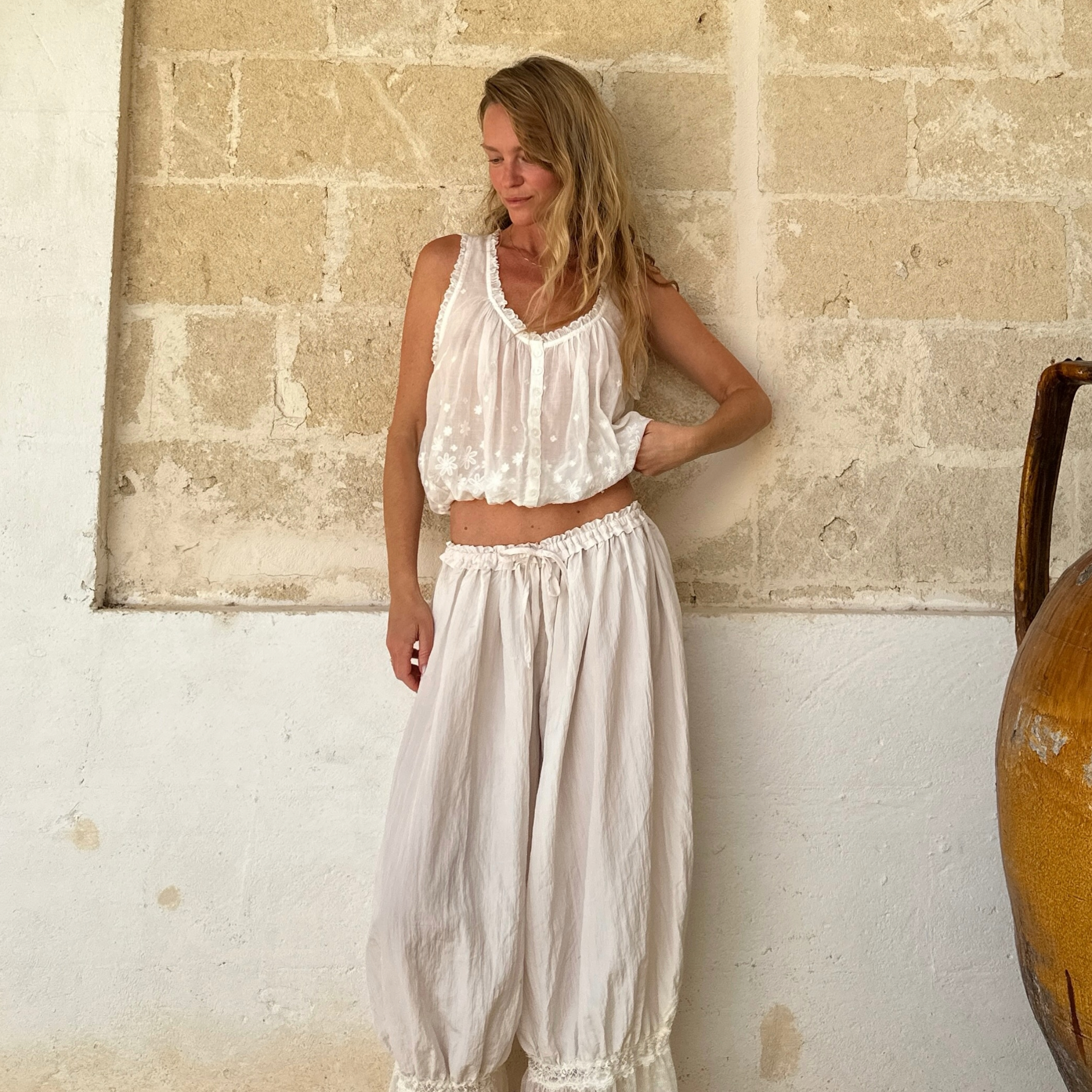 Jeanette Madsen in white embroidered hem pants