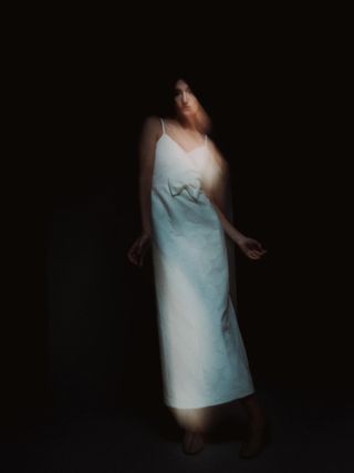 A blurred photo of woman in wedding dress