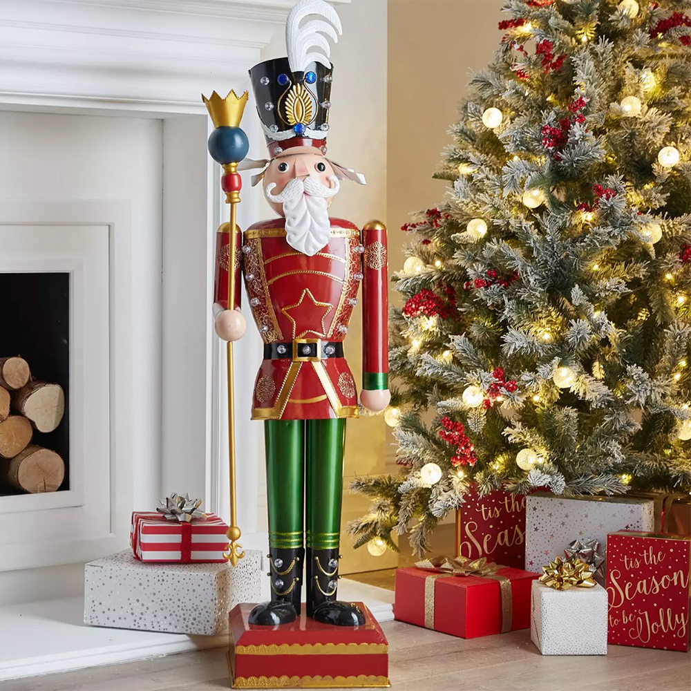 5 ft tall nutcracker figure next to a Chrsitmas tree
