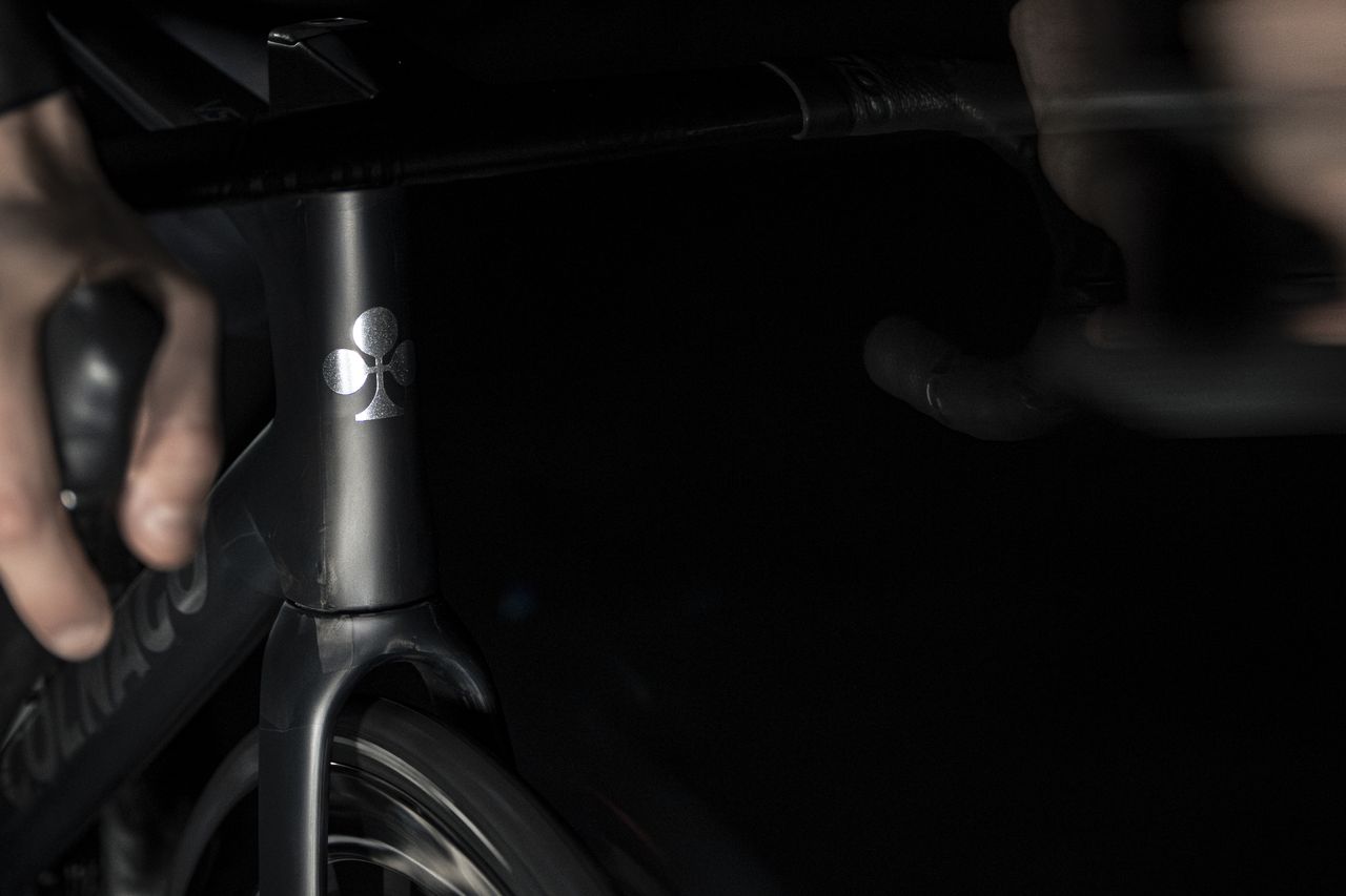 shadowy shots of a black Colnago bike on a black background