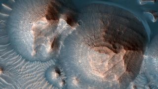 Craters in Mars' Arabia Terra filled with layered rock as seen by NASA's Mars Reconnaissance Orbiter.