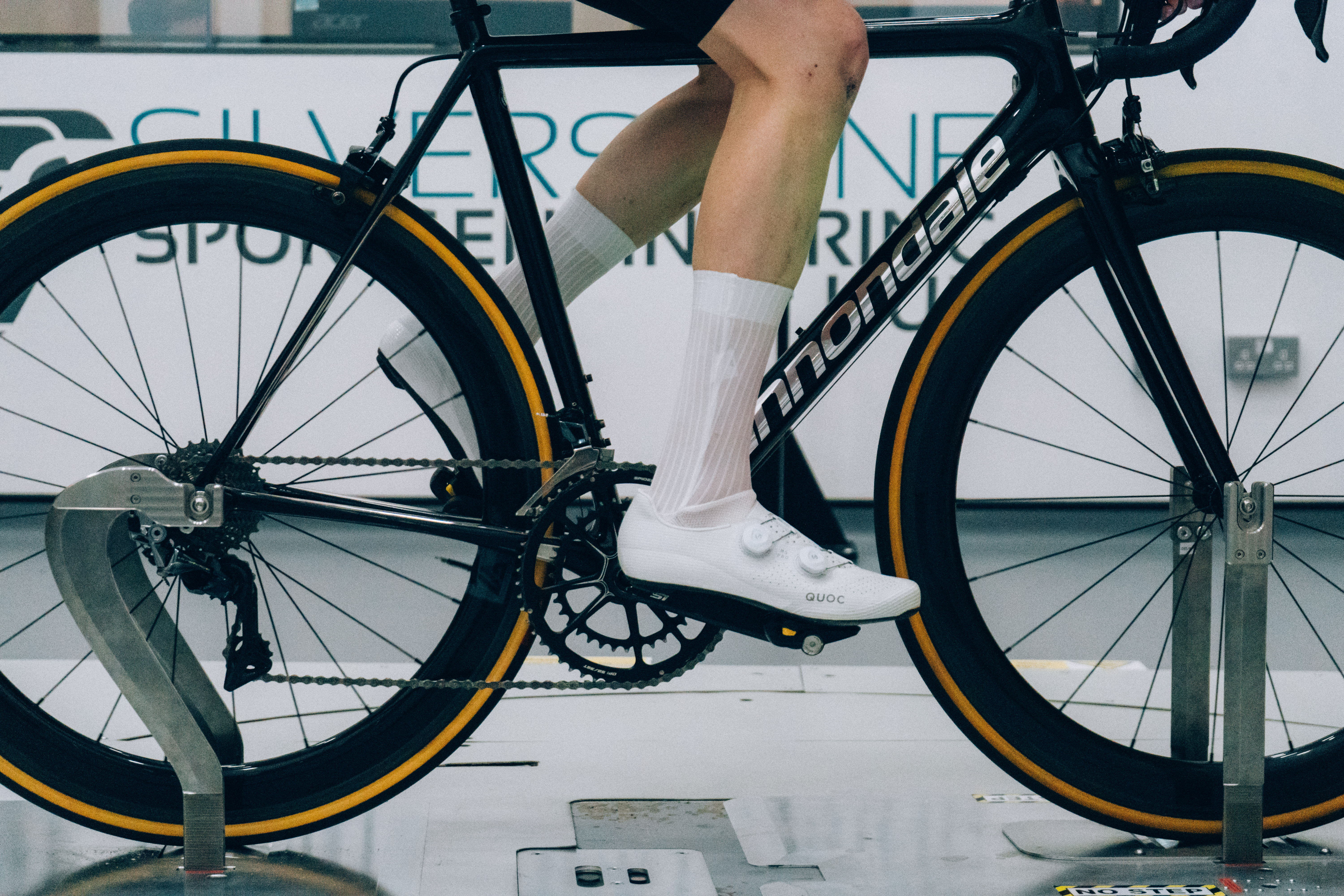 A close up of the socks that Tom is wearing while riding a bike in the wind tunnel