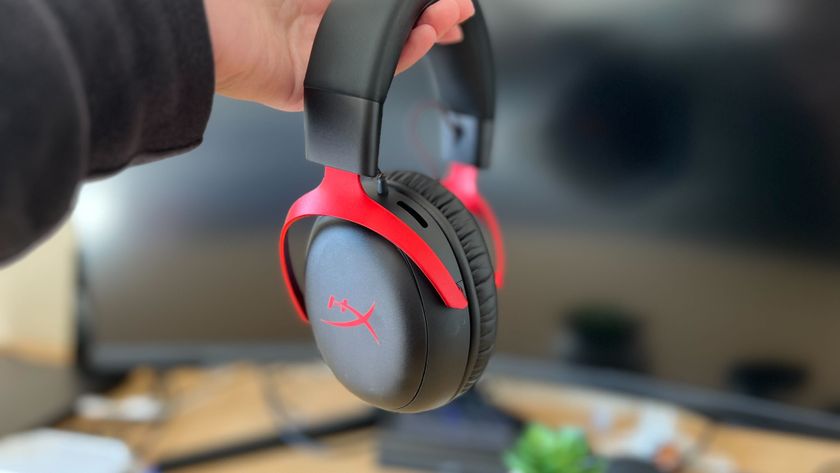 Review holding HyperX Cloud 3 Wireless against a blank monitor screen