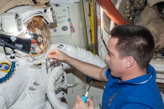NASA astronaut Chris Cassidy studied the spacesuit that leaked while European astronaut Luca Parmitano was wearing it for a spacewalk after the incident.