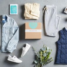 Pieces of clothing scattered around a Stitch Fix box in the centre 
