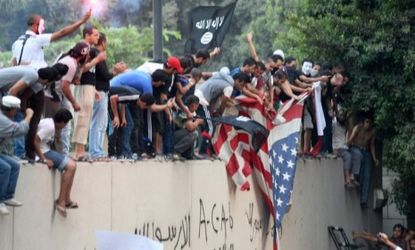 Egyptians replace the American flag with a black Islamic flag at the U.S. embassy in Cairo