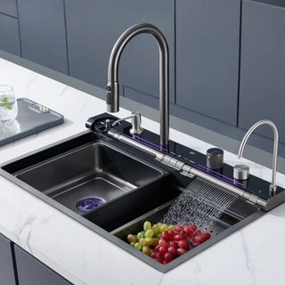 A waterfall kitchen sink in stainless steel