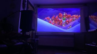 XGIMI Halo+ projector showing movie on screen
