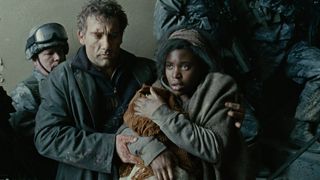 Clive Owen escorts a woman and her child in Children of Men