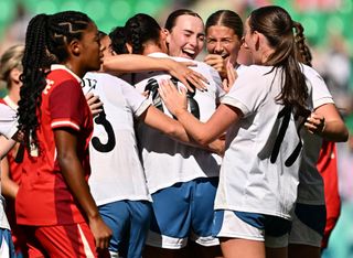 New Zealand's defender #14 Katie Bowen (C) celebrates with teammates after opening the scoring in the women's group A football match between Canada and New Zealand during the Paris 2024 Olympic Games at the Geoffroy-Guichard Stadium in Saint-Etienne on July 25, 2024.