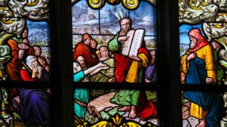 A stained glass window depicting the biblical story of the Ten Commandments.
