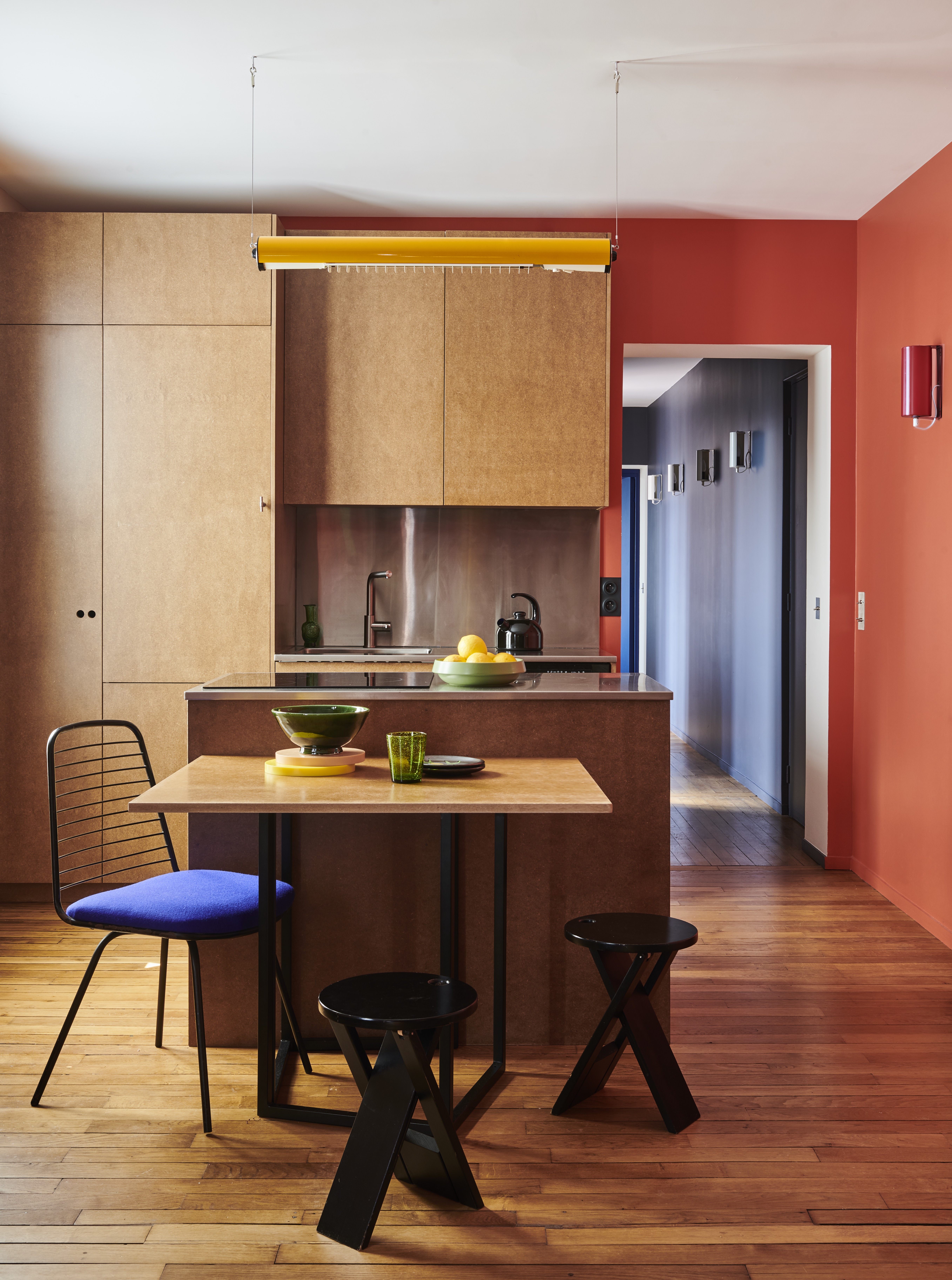 A kitchen in all wood, with a wooden counter and an extended diner