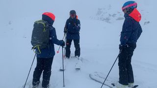 Ski instructor with students on a powder day