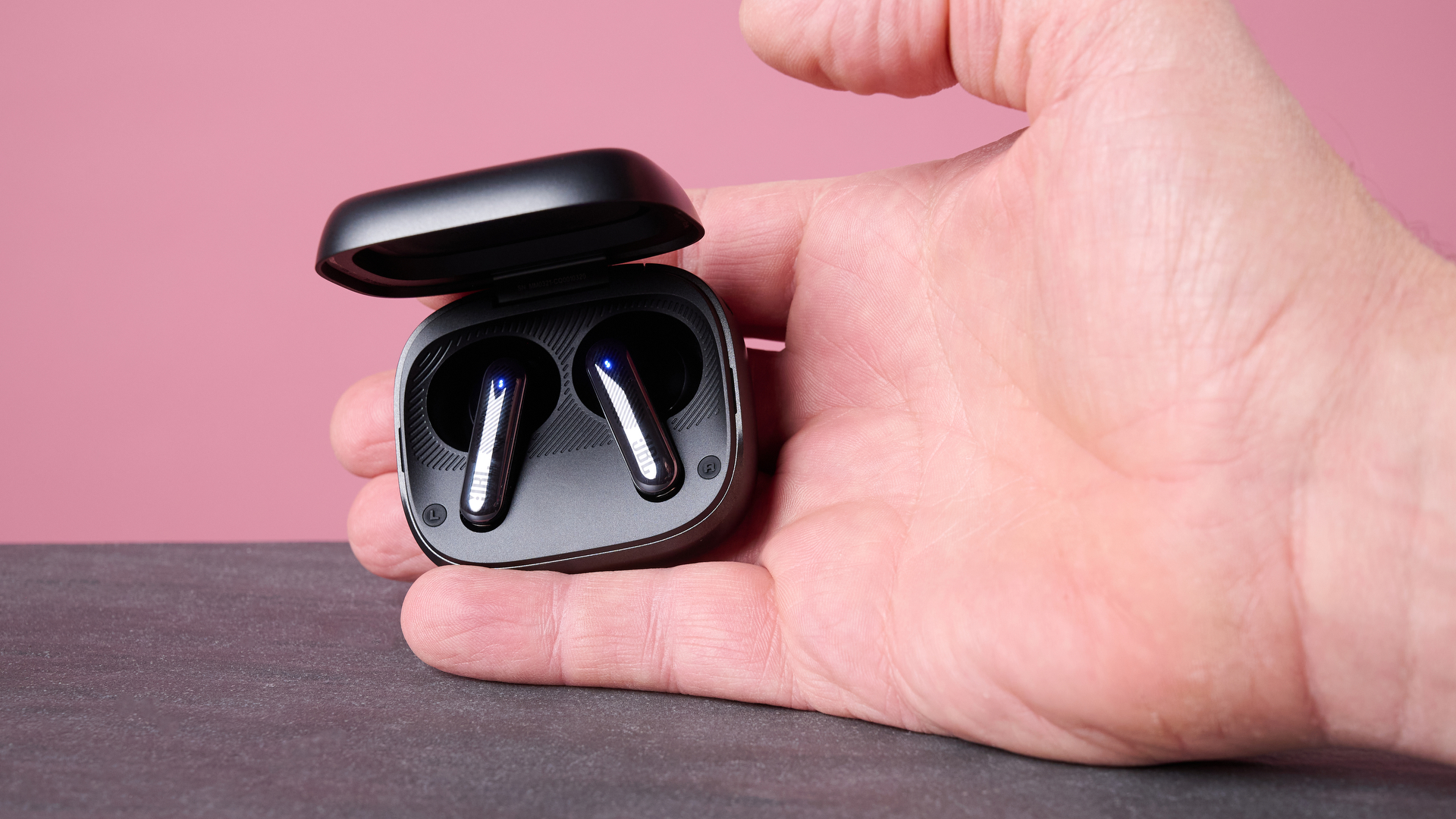 Man holding JBL Live Flex 4 inside charging case
