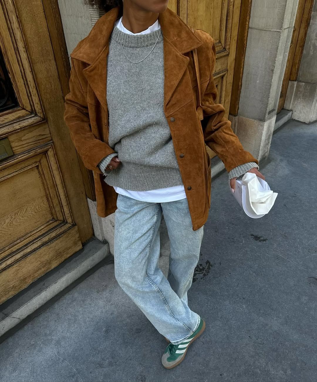 woman wearing suede jacket and jeans