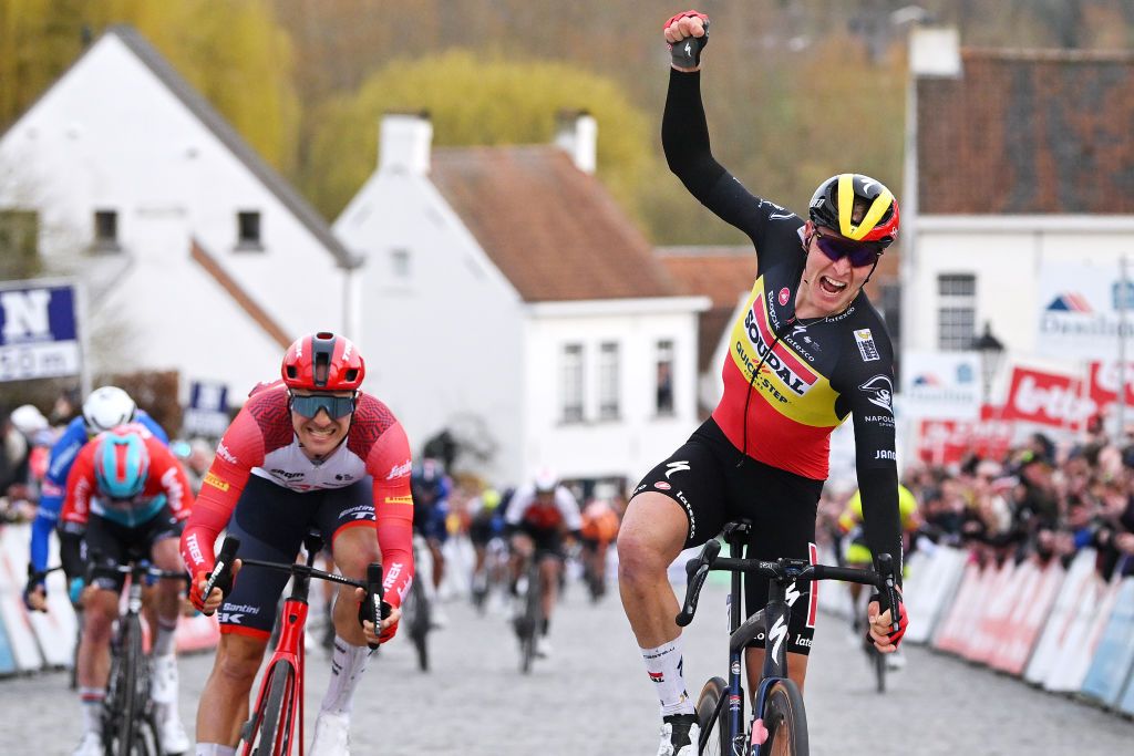 NOKERE BELGIUM MARCH 15 Tim Merlier of Belgium and Team Soudal Quick Step celebrates at finish line as race winner ahead of Edward Theuns of Belgium and Team Trek Segafredo during the 77th Danilith Nokere Koerse 2023 Mens Elite a 1936km one day race from Deinze to Nokere DanilithNokereKoerse on March 15 2023 in Deinze Belgium Photo by Luc ClaessenGetty Images