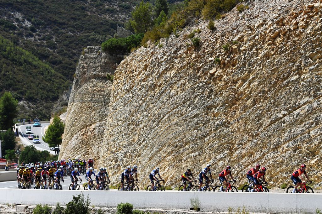 OLIVA SPAIN SEPTEMBER 01 LR Kaden Groves of Australia and Team AlpecinDeceuninck Green Points Jersey Remco Evenepoel of Belgium and Team Soudal Quick Step Geraint Thomas of The United Kingdom and Team INEOS Grenadiers and a general view of the peloton passing through Sot de Chera Village during the 78th Tour of Spain 2023 Stage 7 a 2008km stage from Utiel to Oliva UCIWT on September 01 2023 in Oliva Spain Photo by Tim de WaeleGetty Images