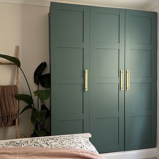 Green Ikea wardrobe transformation in bedroom.
