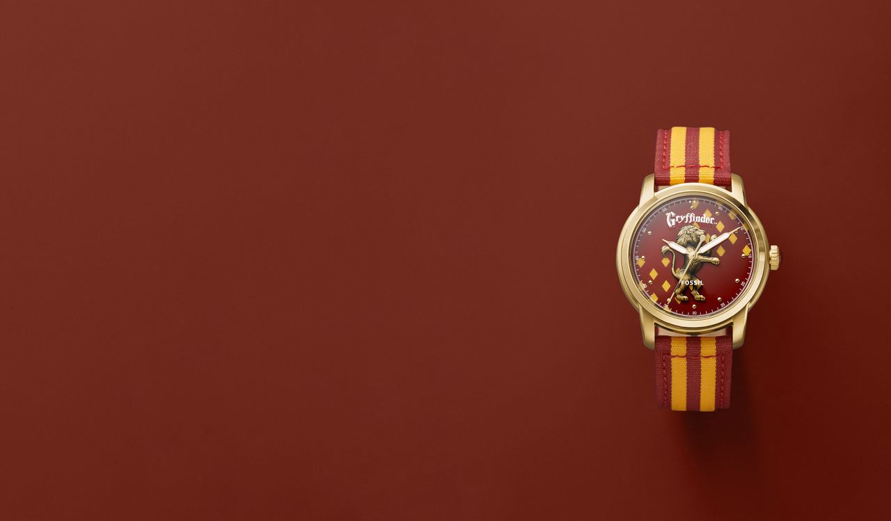 A Harry Potter x Fossil Nylon watch in the Griffindor design, on a red background
