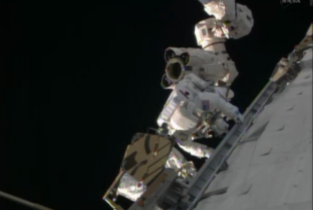 NASA astronaut Rick Mastracchio stands on the International Space Station&#039;s robotic arm during an urgent spacewalk to fix the station&#039;s vital cooling system.