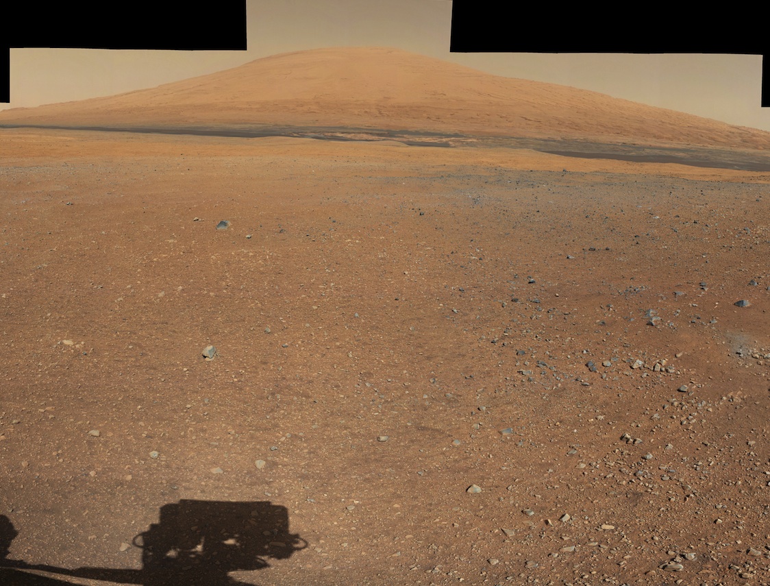 This color panorama shows a 360-degree view of the landing site of NASA's Curiosity rover, including the highest part of Mount Sharp visible to the rover. That part of Mount Sharp is approximately 12 miles (20 kilometers) away from the rover. Scientists enhanced the color in one version to show the Martian scene as it would appear under the lighting conditions we have on Earth, which helps in analyzing the terrain. Photo released August 27, 2012.