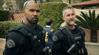Hondo and Deacon in their uniforms standing next to each other on S.W.A.T.