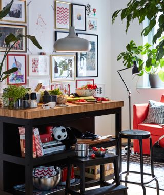 A black butchers block style unit from IKEA in a small kitchen area with seating