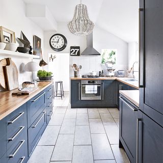 navy kitchen with white tiled floor