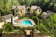 Hotel buildings around a central swimming pool At Farmhouse Inn in California