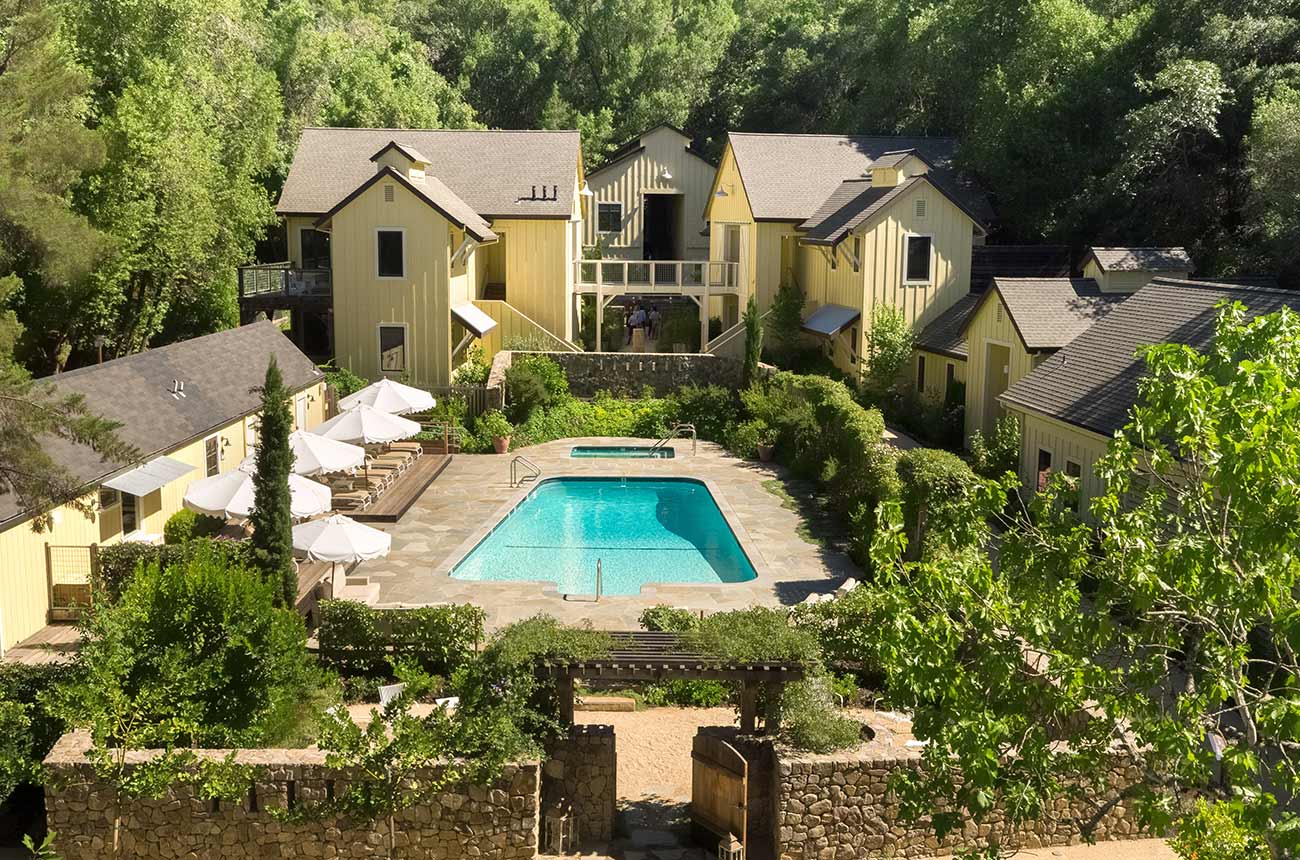 Hotel buildings around a central swimming pool At Farmhouse Inn in California
