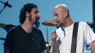 Serj Tankian and Shavo from System Of A Down share a word on stage in 2002