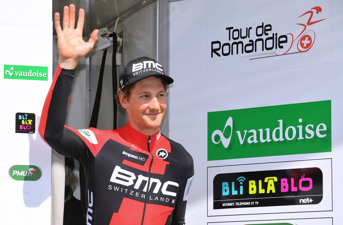 Stefan Kung waves from the podium