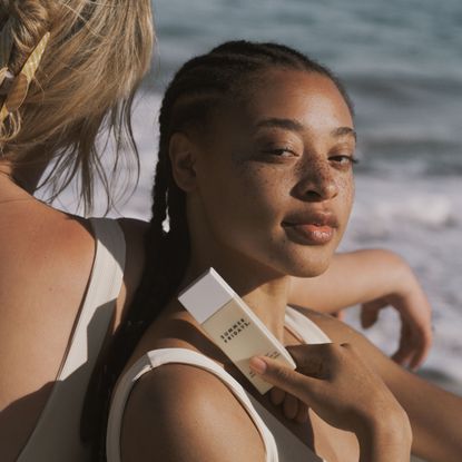 model holding summer fridays sunscreen