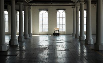 A still from a film celebrating Piero Lissoni furniture for Knoll, set in a warehouse space and shot like a fashion show