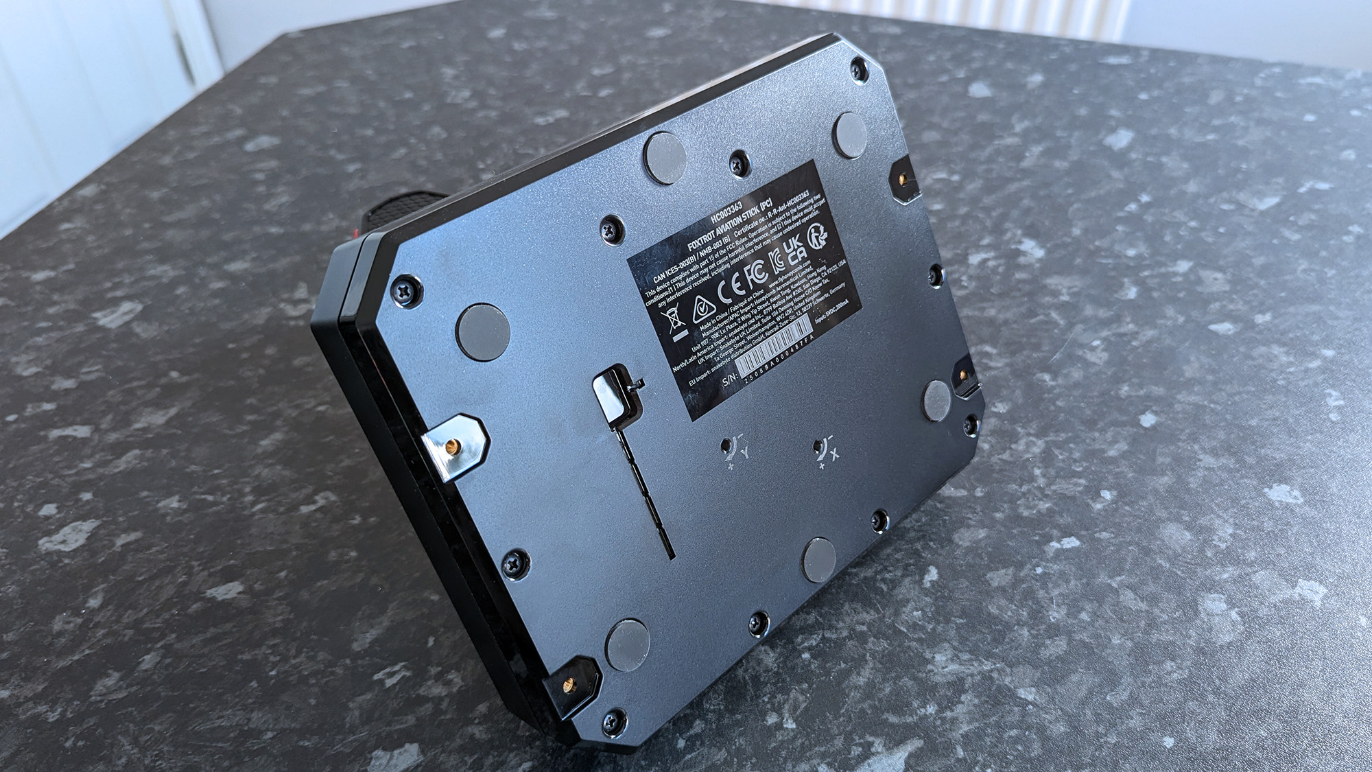 Underside view of a Honeycomb Aeronautical Foxtrot Aviation Stick on a marble-patterned countertop