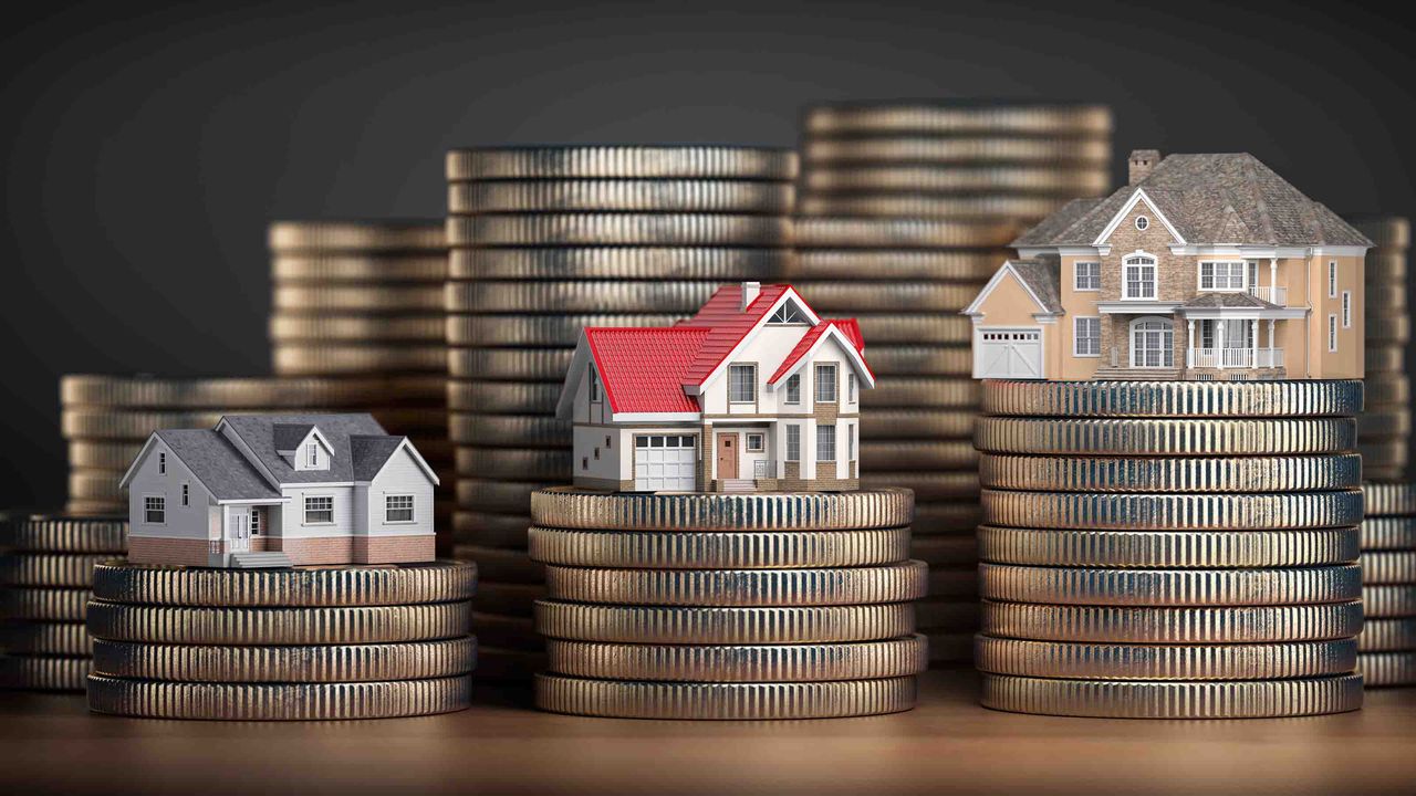 Models of little houses on top of stacks of coins