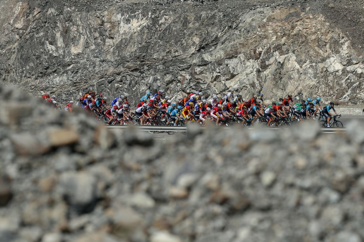The Tour of Oman peloton stands out in the rocky landscape